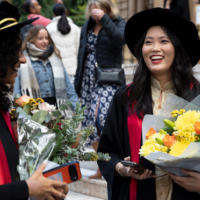A woman singing on stage during the 2025 RACP College Ceremony in Sydney.