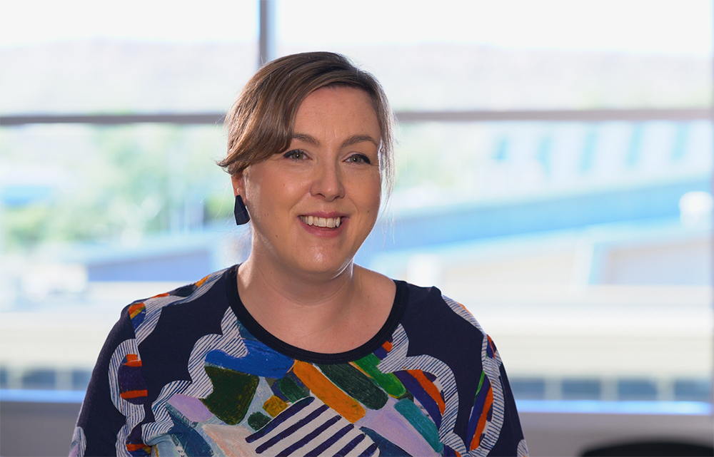 female physician in a hospital smiling 